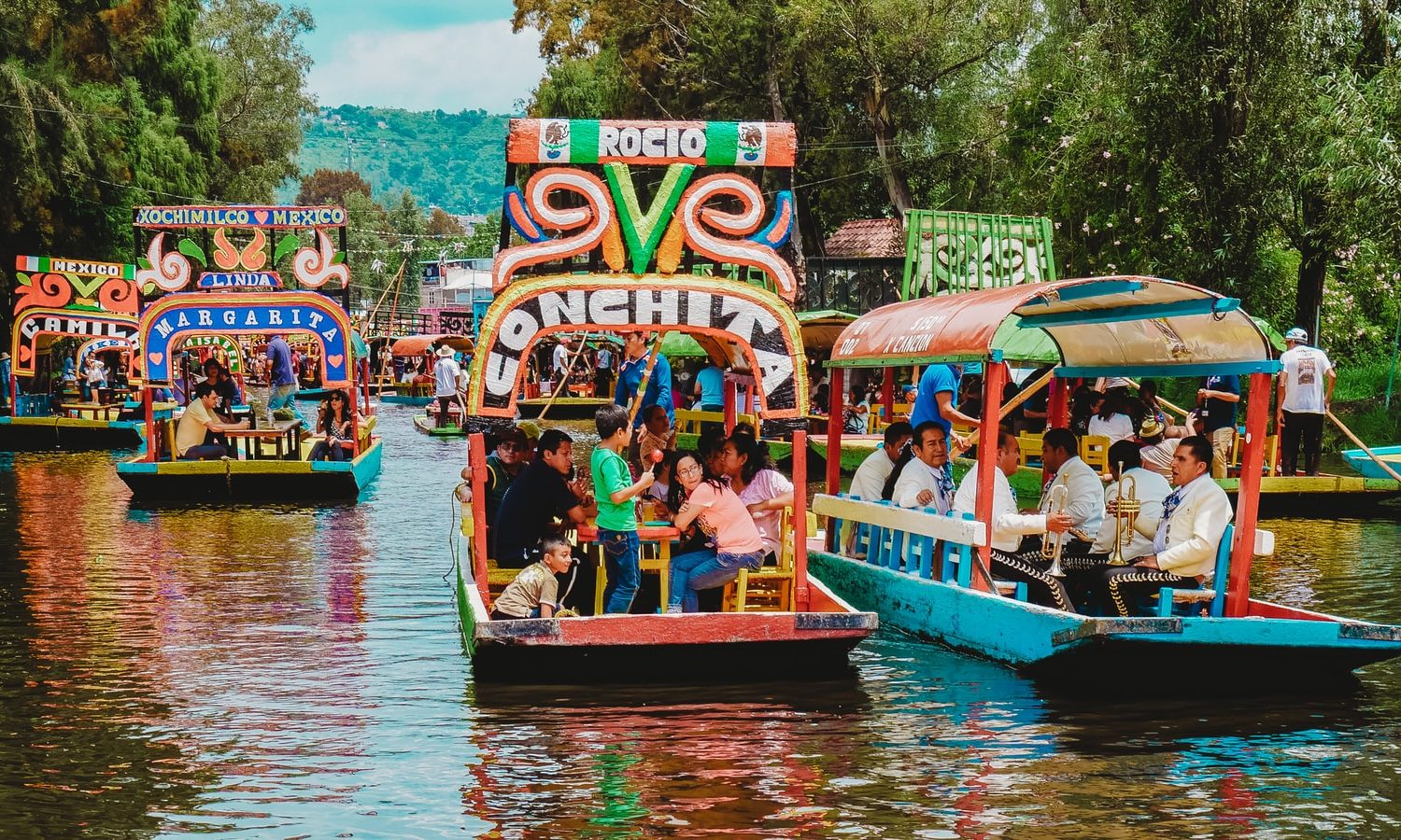 people riding tour boats during daytime