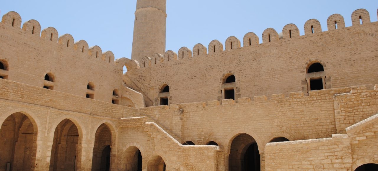 brown concrete building under blue sky during daytime