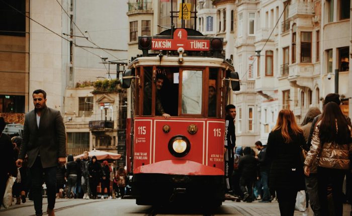 Iconic Istanbul tram navigating through a busy street, capturing urban life and architecture.