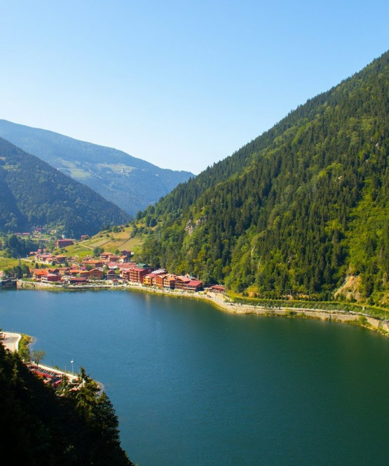 green mountains near body of water during daytime