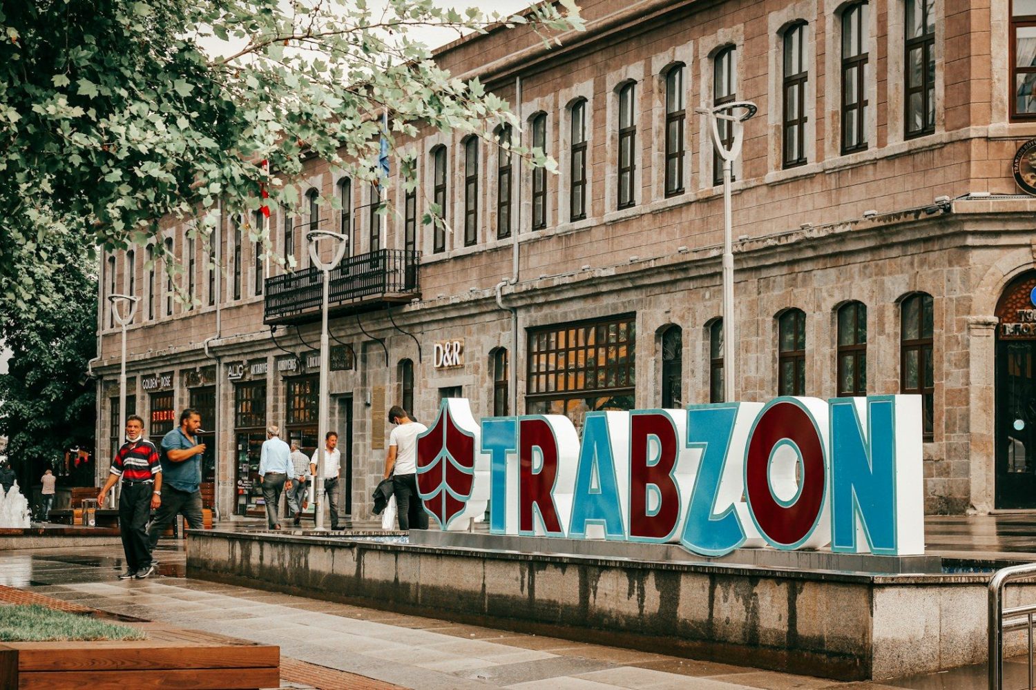 people walking on sidewalk near building during daytime