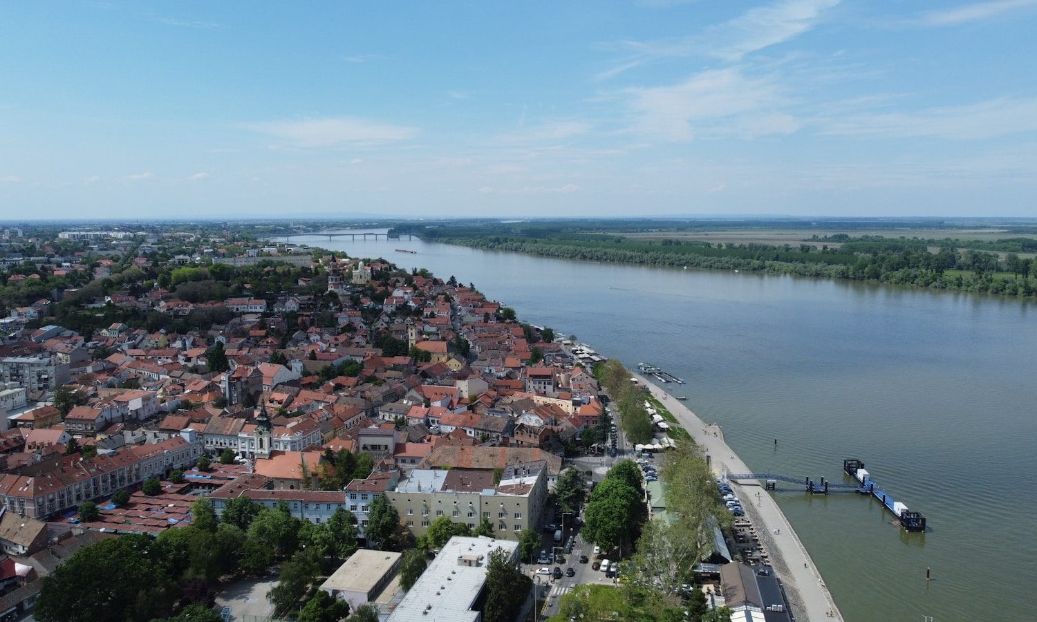 an aerial view of a city next to a river