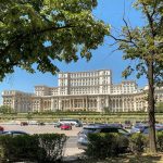 a large building with a lot of cars parked in front of it