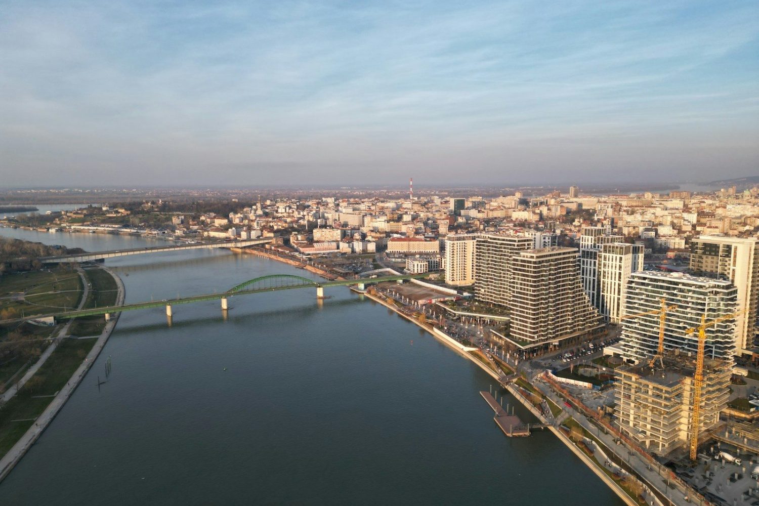 a river running through a city next to a bridge