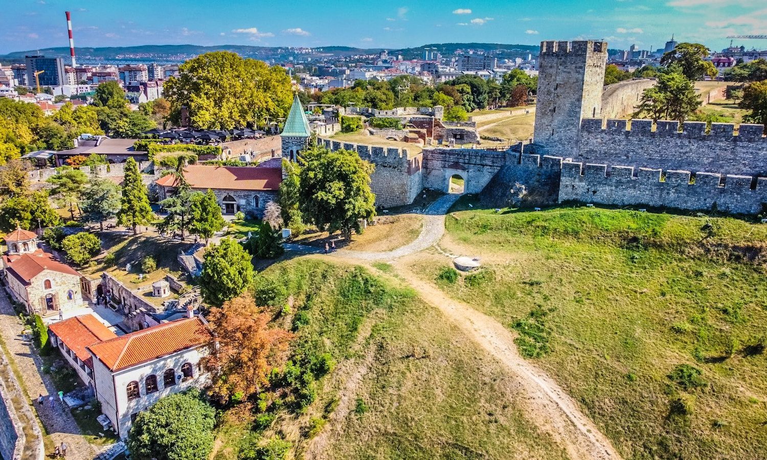 an aerial view of a city with a castle
